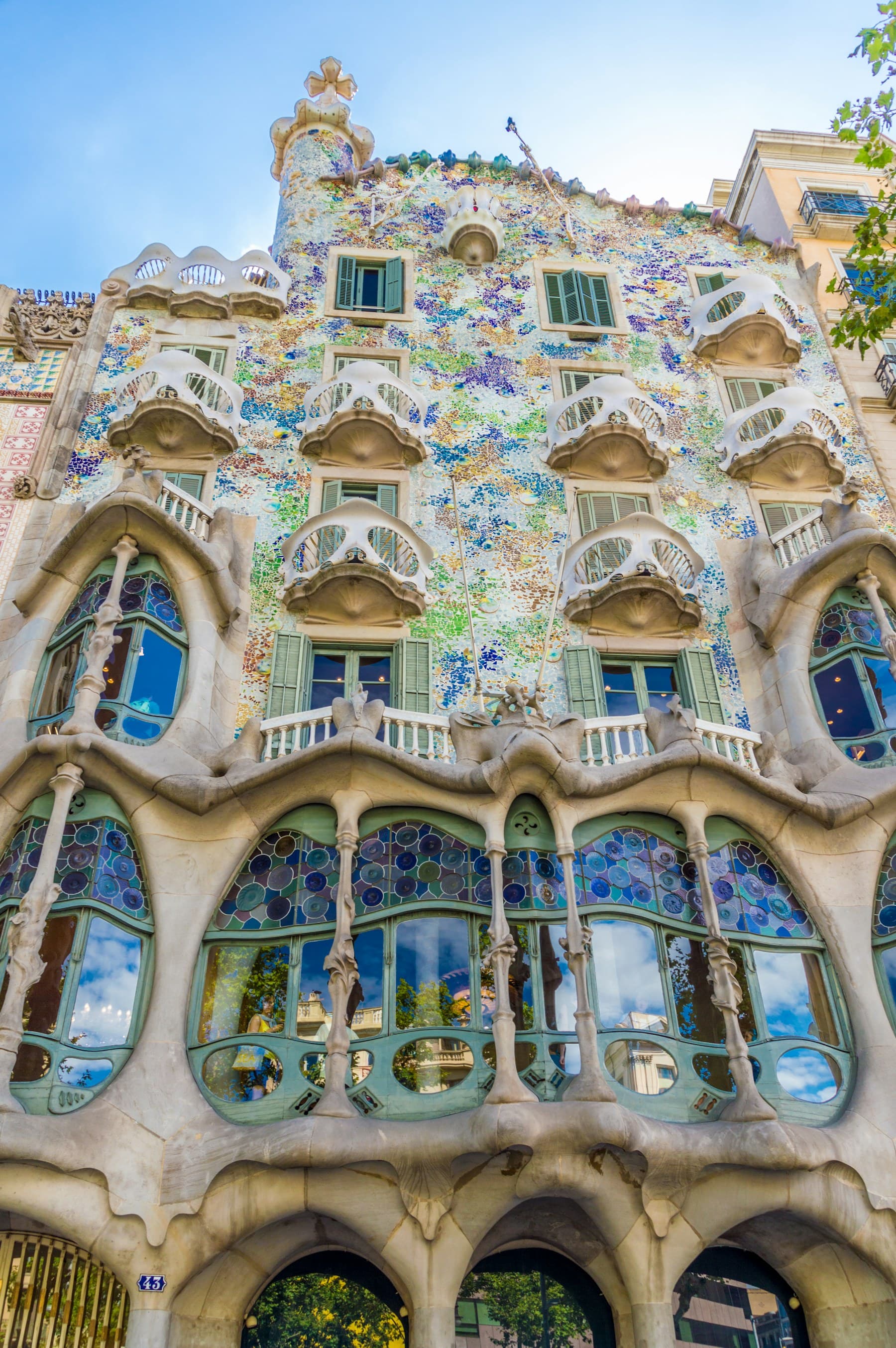 The balconies and mosaic facade of Casa Batlló, seen from the street