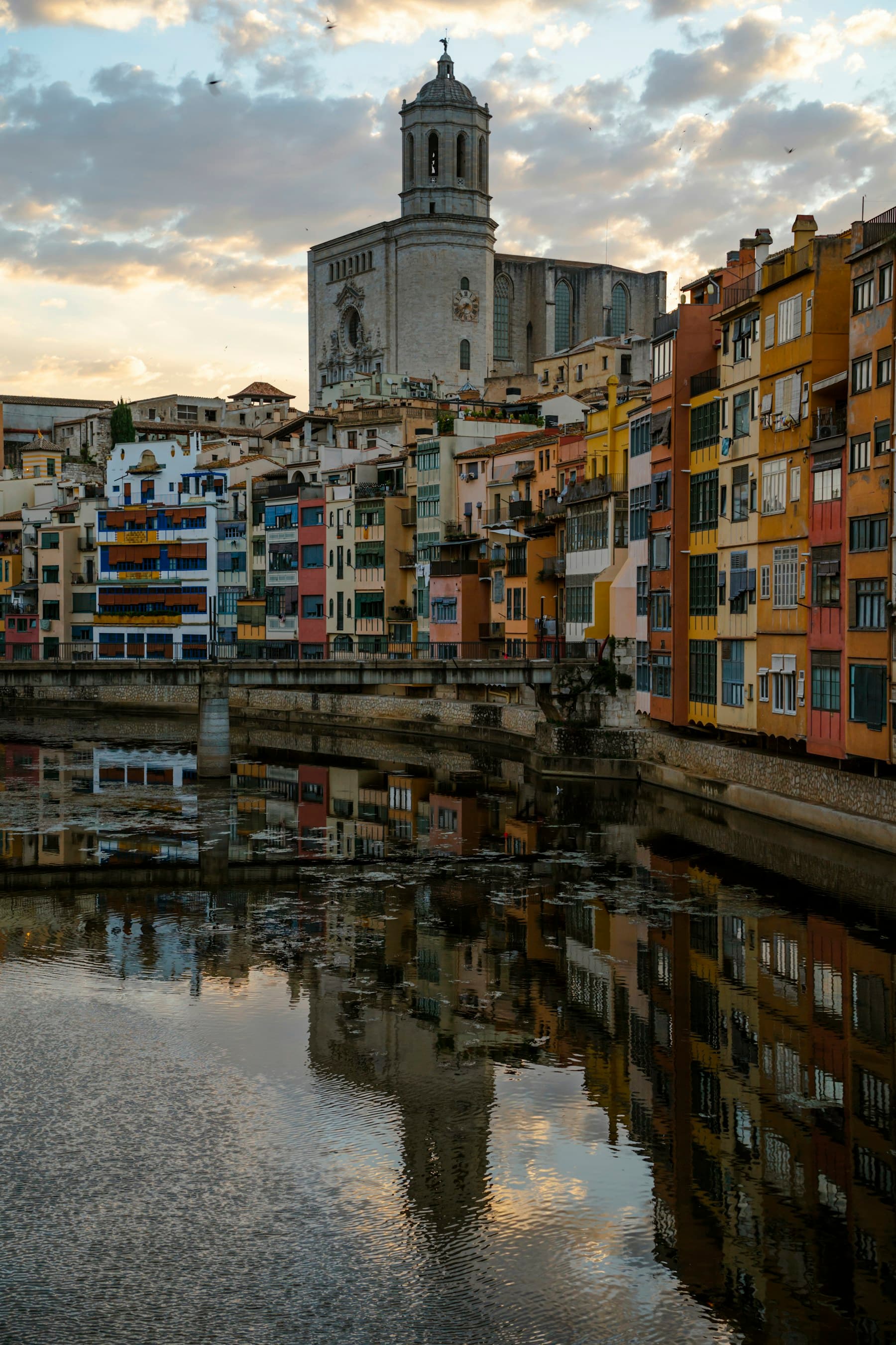 The coloured houses of Girona reflected in the Onyar, the cathedral above