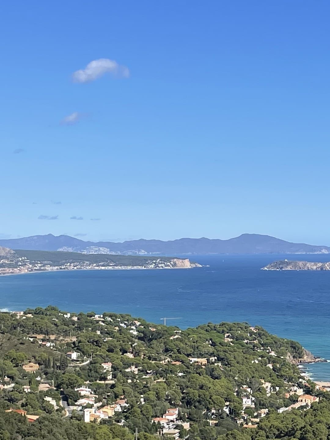 The bay below Begur on the Costa Brava: pines, white villas and the Medes islands in a blue sea