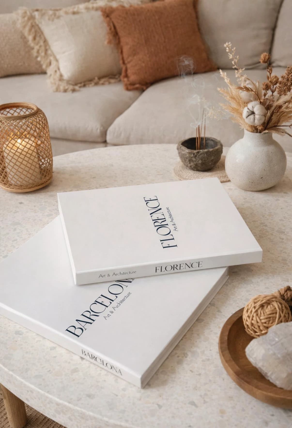 Florence and Barcelona art-and-architecture books on a coffee table in a warm, minimal living room