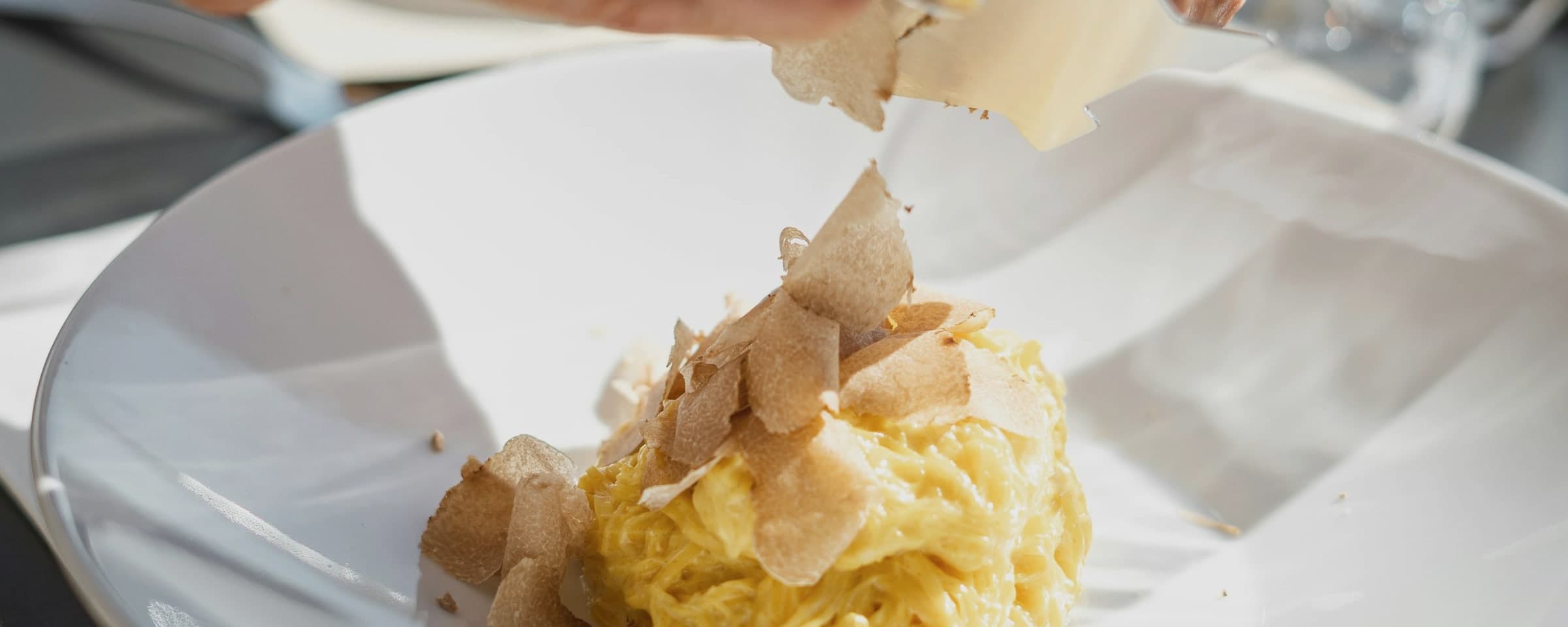 White truffle shaved over fresh egg pasta